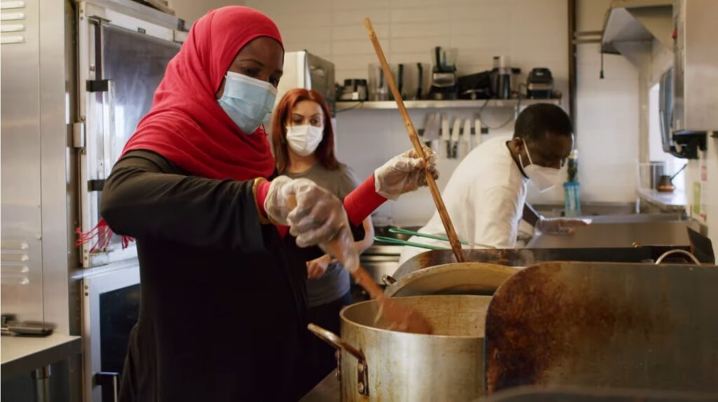 An image of a refugee chef working in the kitchen of Feast World Kitchen.