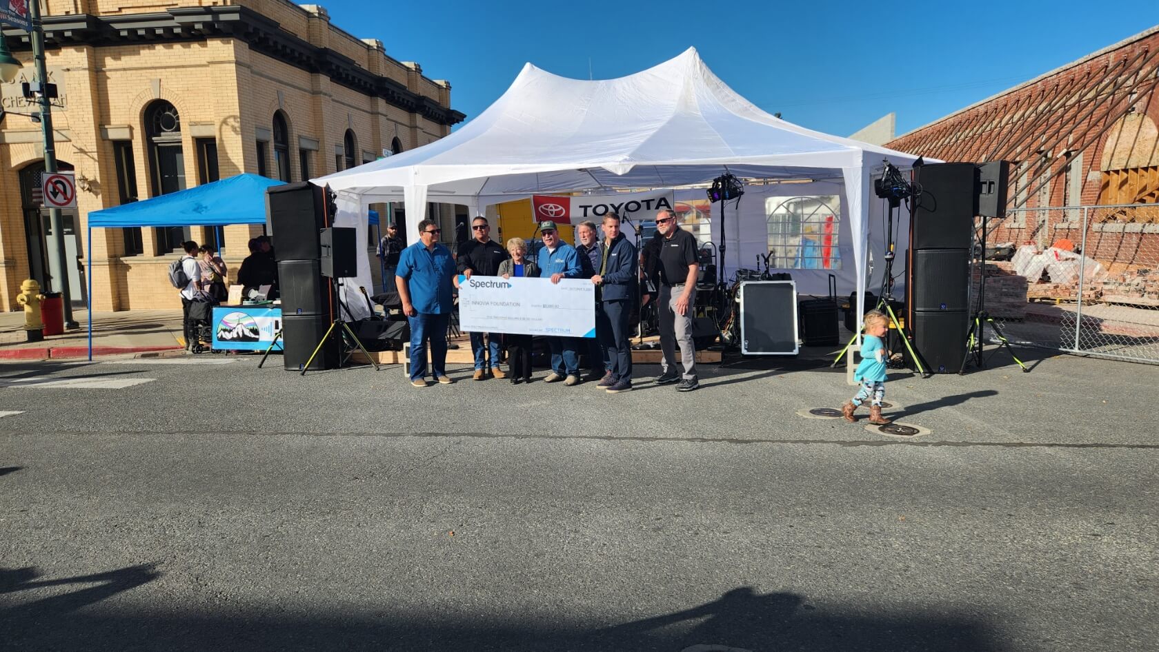 People receive a check outside a tent