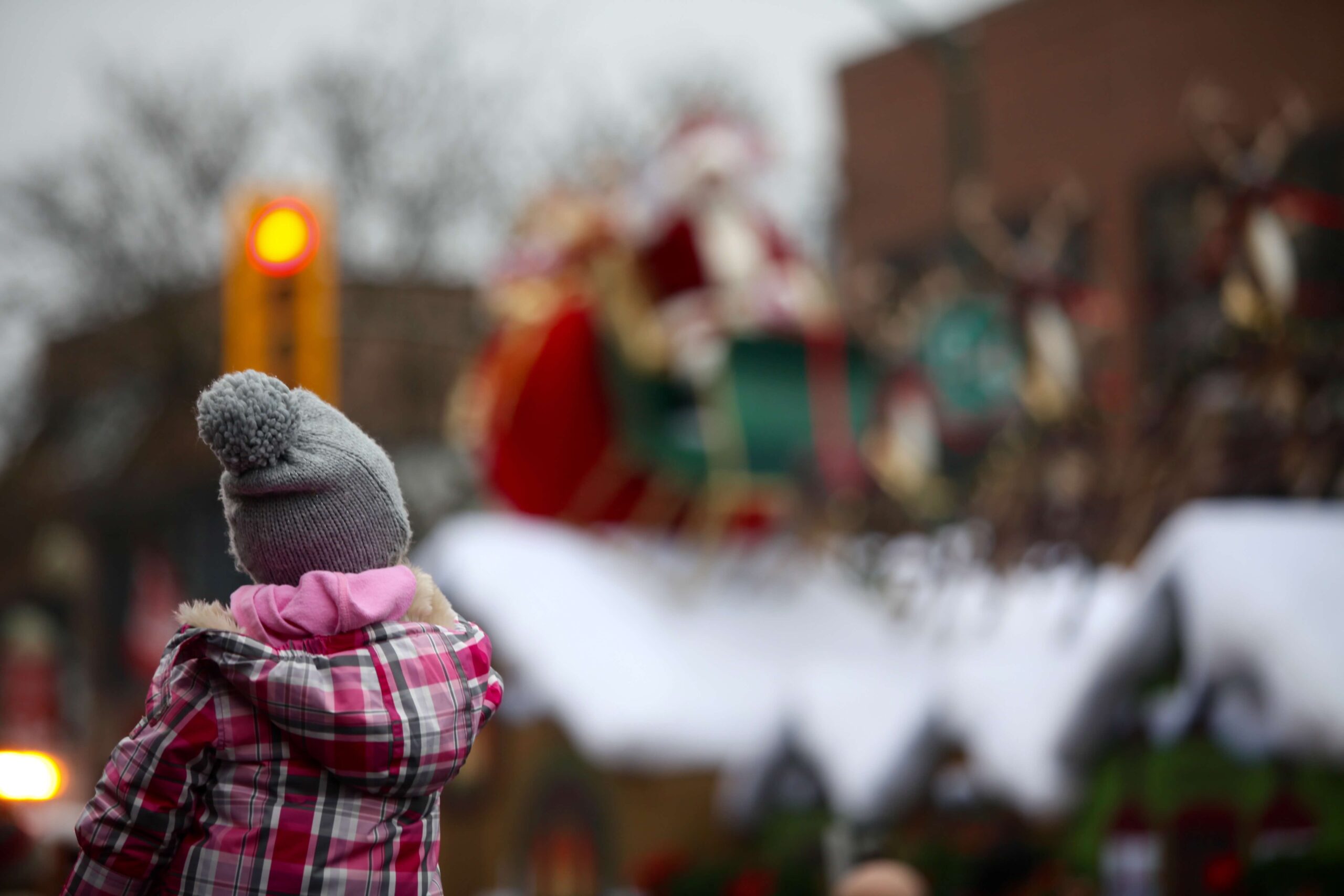 Girl watches Santa at Christmas parade