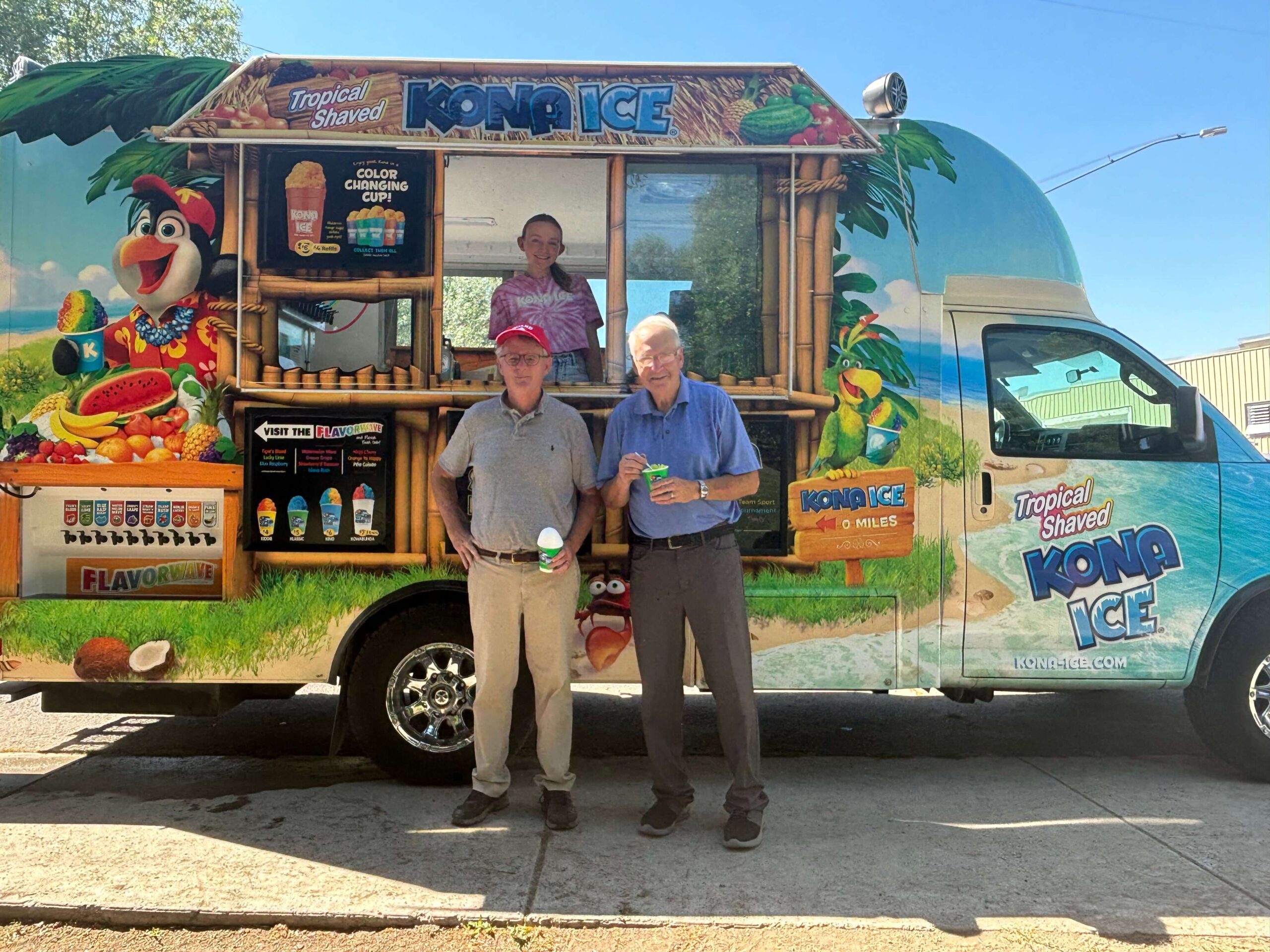 Men eat snow cones by food truck