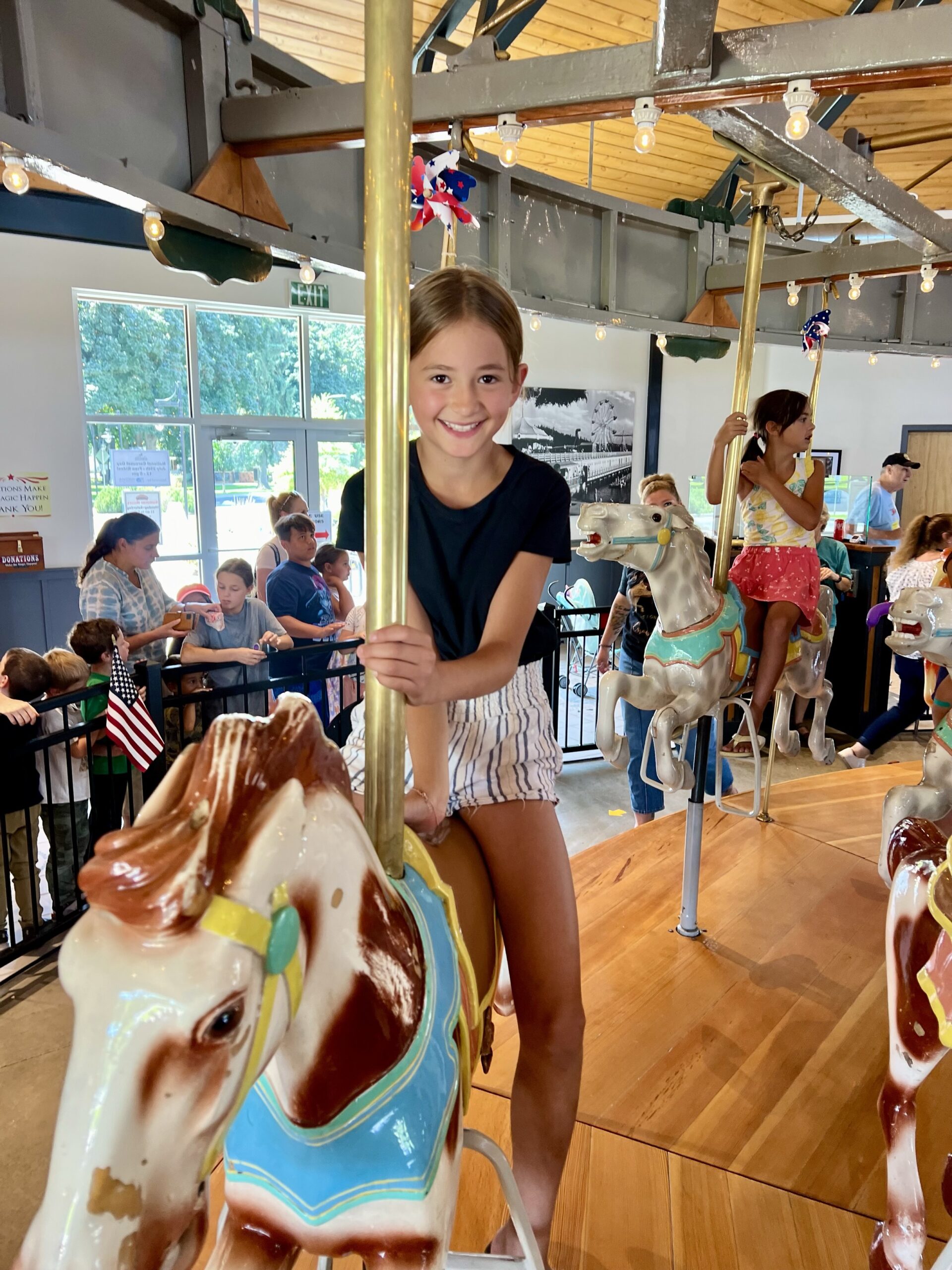 Girl rides on carousel