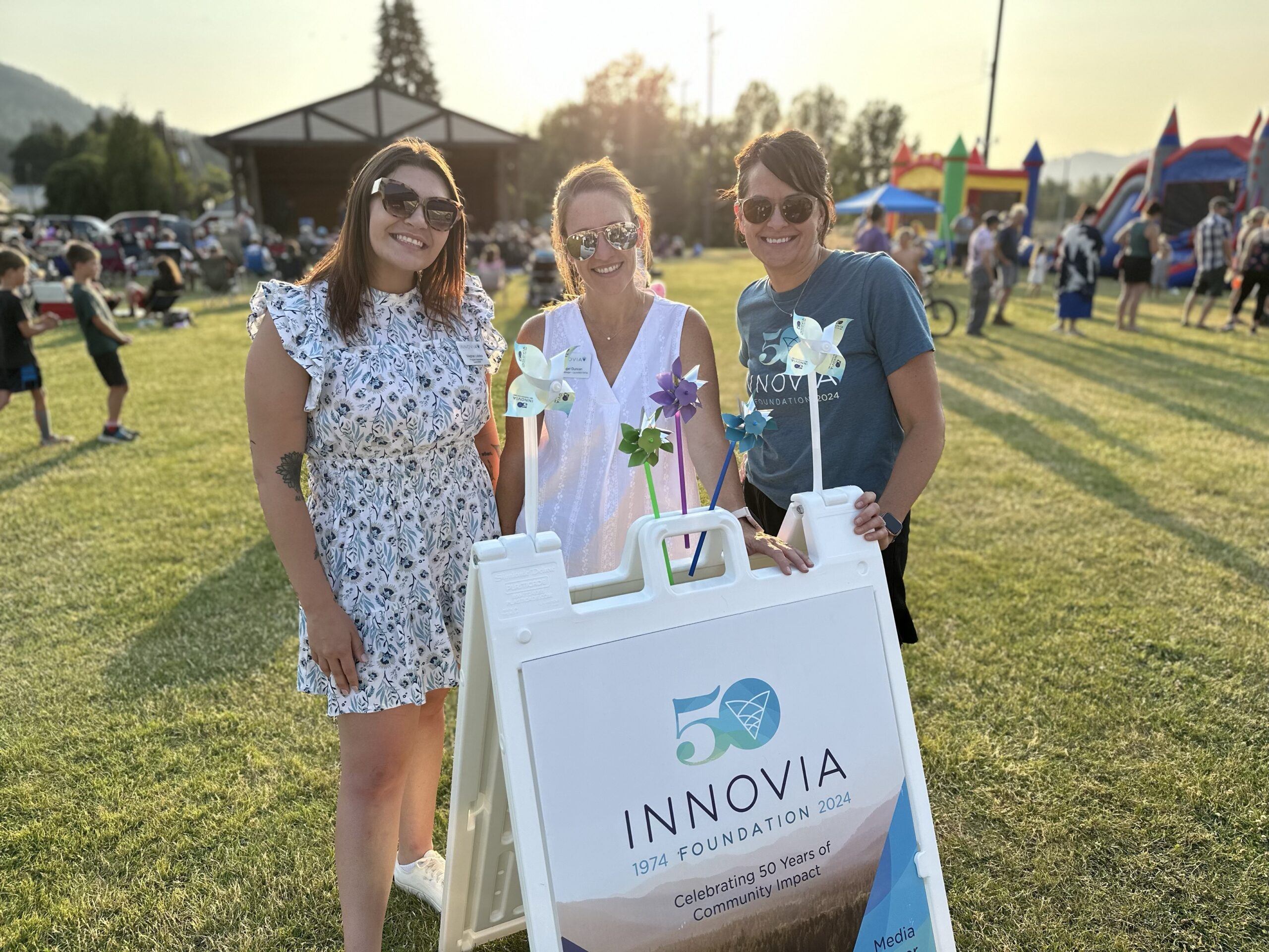 Women next to sign at concert