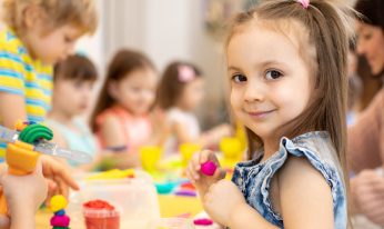 happy kids doing arts and crafts in day care centre