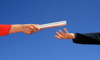 hands passing baton
